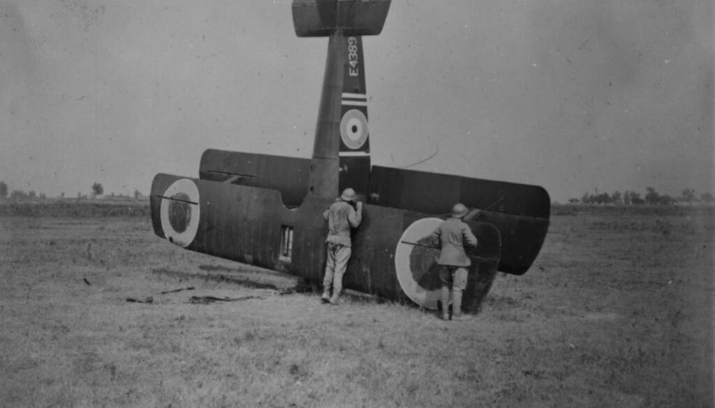 17_[French soldiers examining Sopwith 1F.1 'Camel' aircraft E4389 of the R.A.F. which landed inside Canadian lines near Amiens, France, August 1918.].